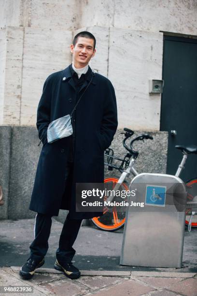 Japanese model Kohei Takabatake wears a black peacoat and a Off-White Goretex bag during Milan Fashion Week Fall/Winter 2018/19 on February 24, 2018...