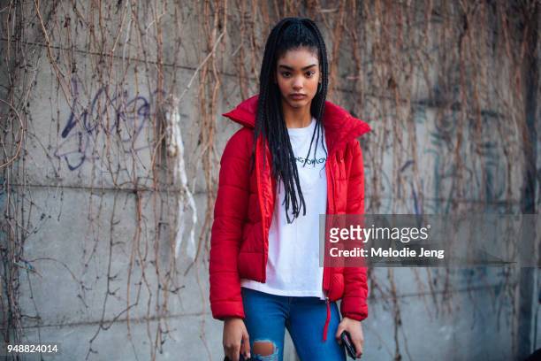 Model Ines Oussaidi wears a red jacket, white t-shirt, and blue jeans during Milan Fashion Week Fall/Winter 2018/19 on February 24, 2018 in Milan,...