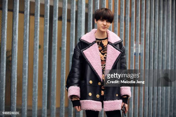 Model Sara Soric wears a black shearling bomber jacket with pink lining over a chinoiserie top during Milan Fashion Week Fall/Winter 2018/19 on...