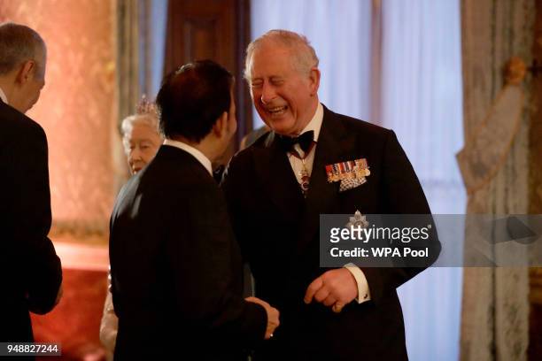 Prince Charles, Prince of Wales greets the Sultan of Brunei Hassanal Bolkiah in a receiving line for the Queen's Dinner for the Commonwealth Heads of...