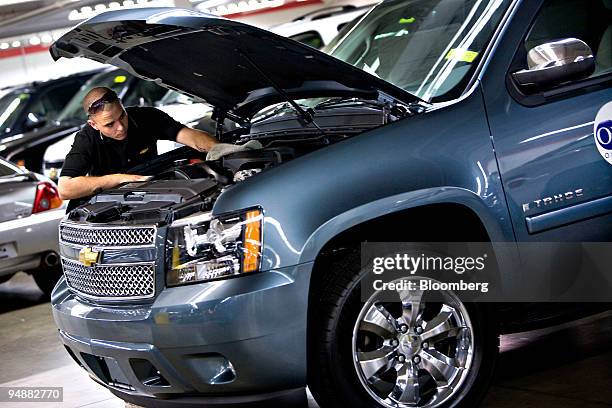 Inventory specilist Shawn Marques prepares a General Motors Corp. Chevrolet Tahoe SUV at Herb Connolly Chevrolet in Framingham, Massachusetts, U.S.,...