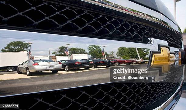 General Motors Corp. Chevrolet brand vehicles are reflected in the grill of a Chevy Silverado pickup truck at Herb Connolly Chevrolet in Framingham,...
