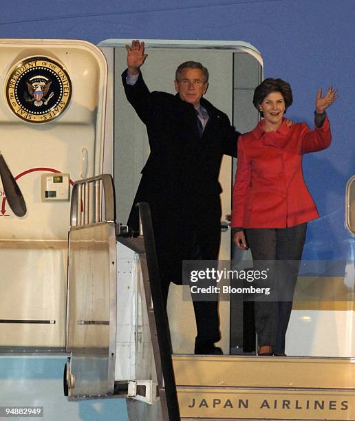 President George W. Bush and First Lady Laura Bush wave as they depart Air Force One upon arrival at Osaka International Airport Tuesday, November...