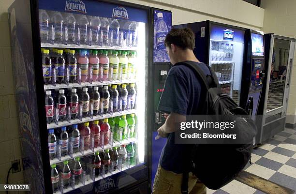 Student at Wethersfield High School in Wethersfield, Connecticut purchases a soft drink from a a vending machine in the school cafeteria early in the...