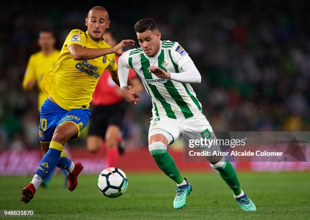 Arnaldo Antonio Sanabria of Real Betis Balompie competes for the ball with Alejandro Galvez of Union Deportiva Las Palmas during the La Liga match...