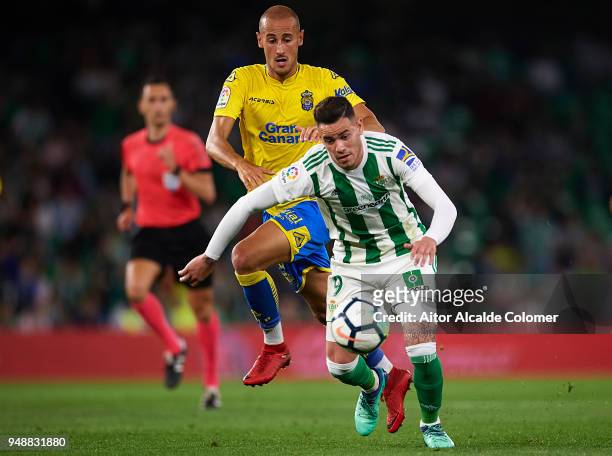 Arnaldo Antonio Sanabria of Real Betis Balompie competes for the ball with Alejandro Galvez of Union Deportiva Las Palmas during the La Liga match...