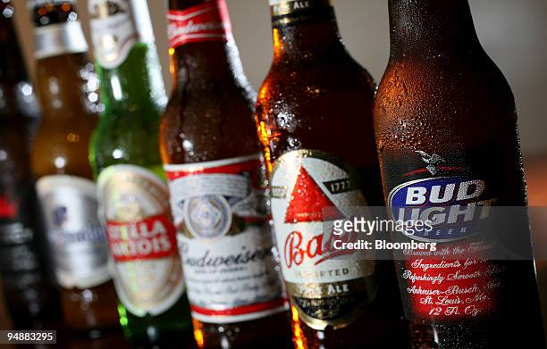 Bottles of Anheuser-Busch's Bud Light, Budweiser and Budweiser Select and InBev NV's Bass, Stella Artois, and Hoegarden are arranged for a photograph...