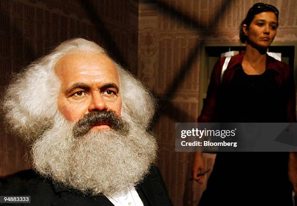 Visitor passes a wax figure of Karl Max, 19th-century Prussian philosopher, on display at Madame Tussauds prior to the exhibition's public opening,...