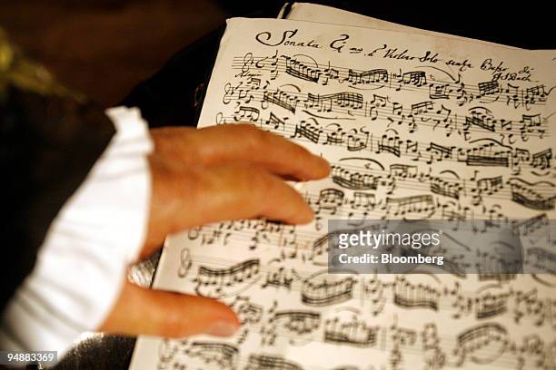 Wax figure of Johann Sebastian Bach, German composer, rests its hand on sheet music for a violin sonata, on display at Madame Tussauds prior to the...