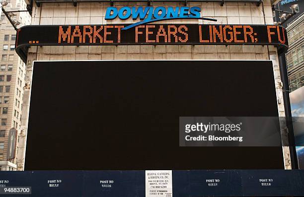 The Dow Jones news ticker in Times Square reads "Market Fears Linger" in New York, U.S., on Friday, June 27, 2008. U.S. Stocks rose, paring a fourth...