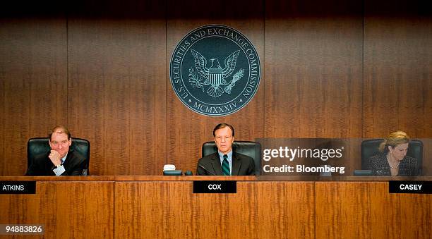 Christopher Cox, chairman of the U.S. Securities and Exchange Commission, center, listens along with SEC commissioners Paul Atkins, left, and...