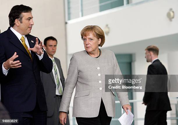 Mikheil Saakashvili, Georgia's president, left, speaks to Angela Merkel, Germany's chancellor, left, as they arrive for a news conference in Berlin,...