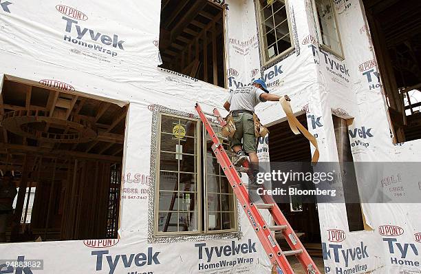 Carpenter works on a new home under construction in Park Ridge, Illinois, U.S., on Tuesday, June 24, 2008. Sales of new U.S. Houses fell 2.5 percent...