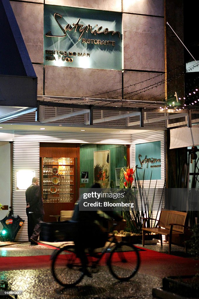 A bicyclist passes by the Satyricon restaurant in the Ipanem