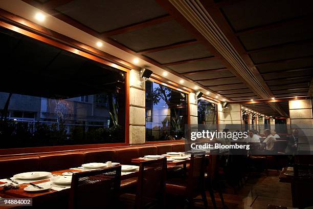 Chef sits with patrons at Esplanada Grill restaurant in the Ipanema district of Rio de Janeiro, Brazil, on Monday, June 23, 2008. Grill Esplanada is...