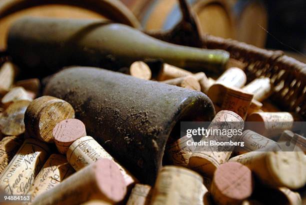 Old and dusty wine bottles sit in the cellar at the Clos Saint Jean vineyard, in the Burgundy village of Chassagne-Montrachet, France, on Tuesday,...