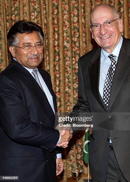 Pascal Couchepin, president of the Swiss confederation and federal councilor of home affairs, right, shakes hands with Pervez Musharraf, president of...