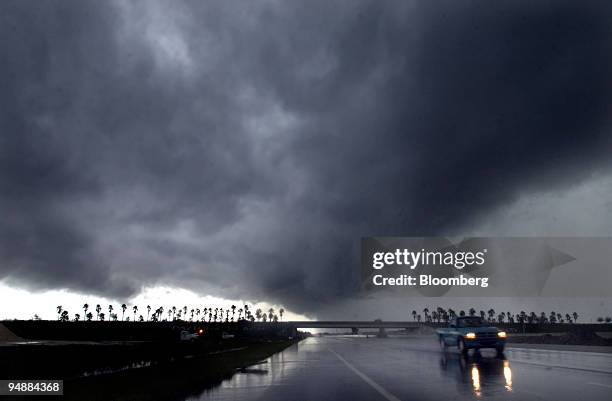 Squall line of clouds and heavy rain frames traffic along Interstate 95 Monday September 6, 2004 in Daytona, Florida, after Hurricane Frances brought...