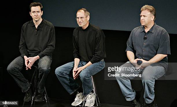 Steve Jobs, chief executive officer of Apple Inc., center, speaks during a news conference with Phil Schiller, product marketing manager, right, and...