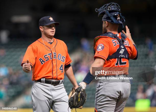 Brad Peacock of the Houston Astros is greeted by Max Stassi after securing the win against the Seattle Mariners at Safeco Field on April 19, 2018 in...