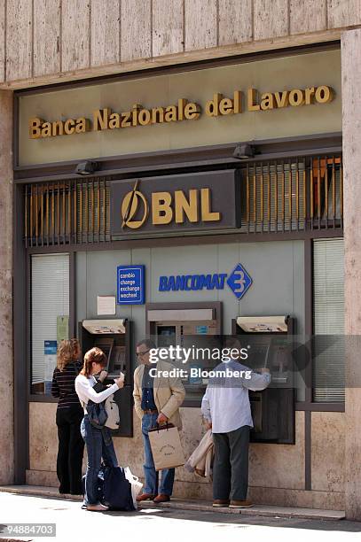 Customers use an ATM at branch of the Banca Nazionale del Lavoro Bank in Rome, Italy, Monday, March 23, 2005. The European Commission is asking the...