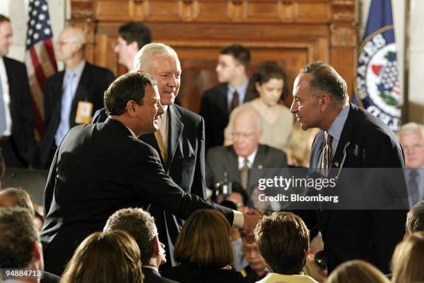 Supreme Court Chief Justice nominee John Roberts, left, shakes hands with Senator Charles Schumer prior to his testimony before the Senate Judiciary...