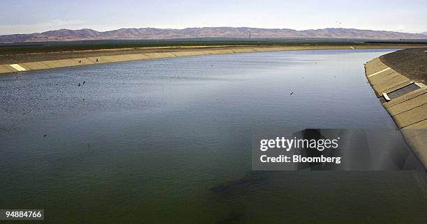 Water from the nearby Sierra Nevada Mountains flows through the California Aqueduct in the San Joaquin Valley near Firebaugh, California, U.S., on...