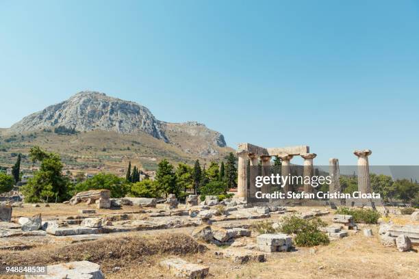 greece, peloponnese, view of ancient ruins of temple of apollo - templo de apolo corinto imagens e fotografias de stock