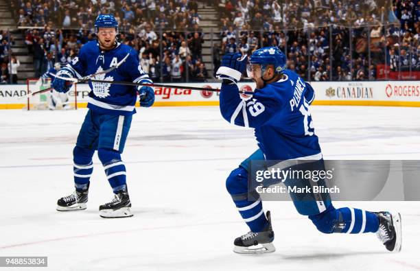 Tomas Plekanec of the Toronto Maple Leafs celebrates with teammate Morgan Rielly after scoring on the Boston Bruins in Game Four of the Eastern...