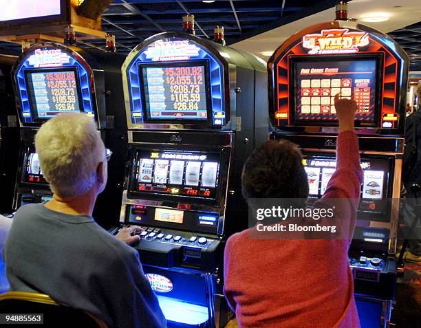 Patrons play the first slot machine gaming available in Pennsylvania at the Mohegan Sun at Pocono Downs Thursday, November 16, 2006 in Wilkes-Barre,...