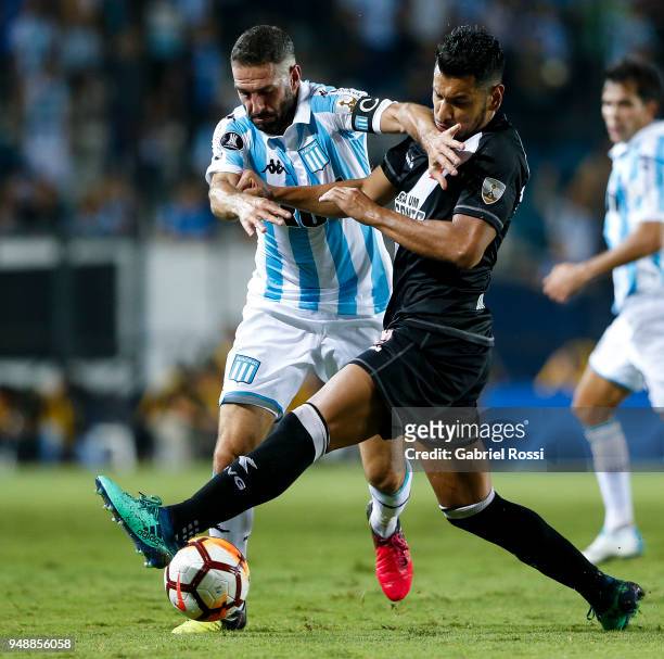 Lisandro Lopez of Racing Club fights for the ball with Andrés Ríos of Vasco Da Gama during a match between Racing Club and Vasco da Gama as part of...