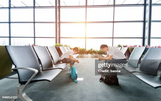 father and son waiting at airport - asian waiting angry expressions stock pictures, royalty-free photos & images
