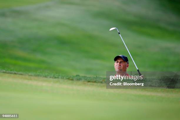 Stewart Cink of the U.S. Team watches his approach shot on the 4th hole during a singles match against Graeme McDowell of the European team on day...