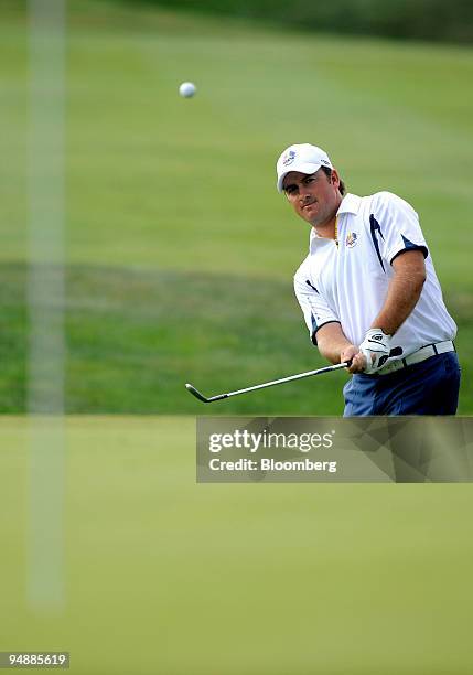 Graeme McDowell of the European team chips a shot onto the 4th green during a singles match against Stewart Cink of the U.S. Team on day three of the...