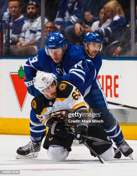 Morgan Rielly of the Toronto Maple Leafs checks Brad Marchand of the Boston Bruins in Game Four of the Eastern Conference First Round during the 2018...