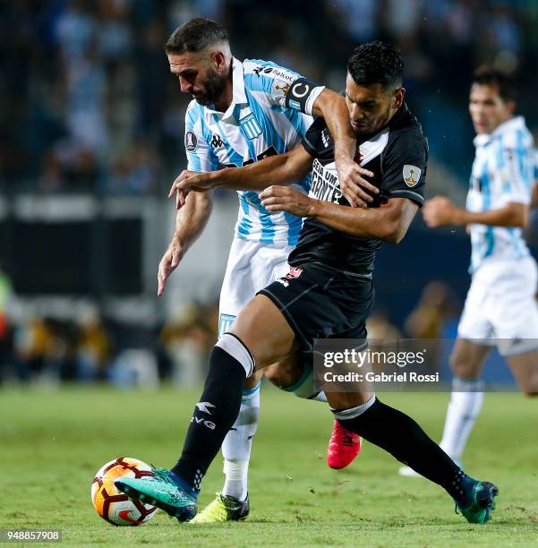Lisandro Lopez of Racing Club fights for the ball with Andrés Ríos of Vasco Da Gama during a match between Racing Club and Vasco da Gama as part of...