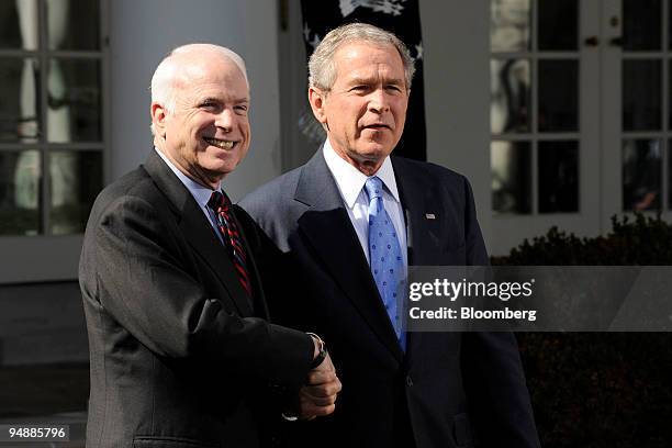 John McCain, U.S. Senator from Arizona and 2008 Republican presidential candidate, left, shakes hands with U.S. President George W. Bush during a...