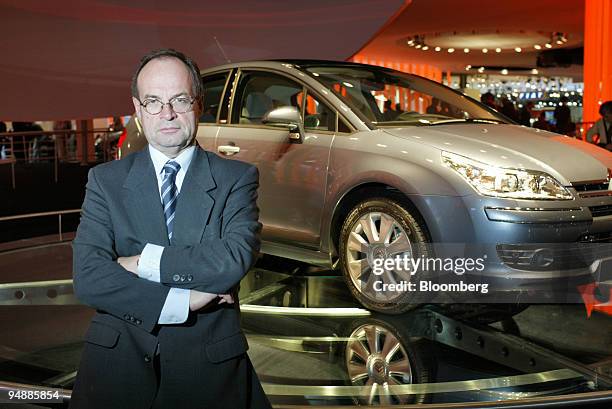 Peugeot Citroen chief executive Jean-Martin Folz poses in front of a C4 compact hatchback at the Paris Motor Show in Paris, France Thursday,...