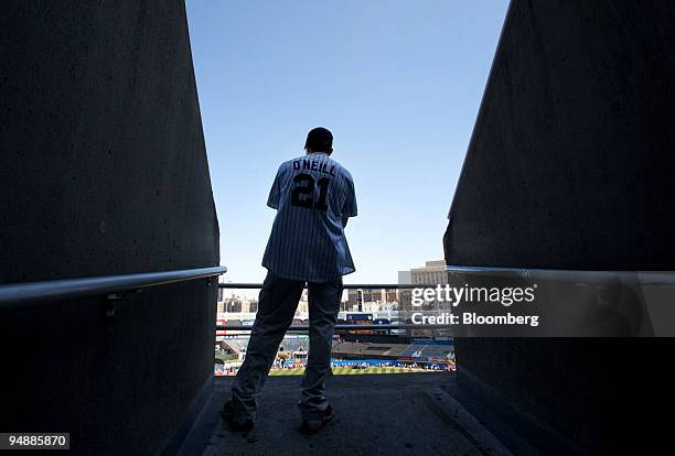 Fan wearing a Paul O'Neill jersey stands in the upper deck tunnel at Yankee Stadium before a game between the Baltimore Orioles and New York Yankees...