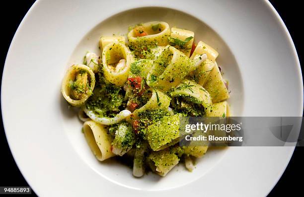 Dish of calamarata pasta served with mixed seafood, sea urchin and minted bread crumbs is arranged for a photo before dinner service at Scarpetta, an...