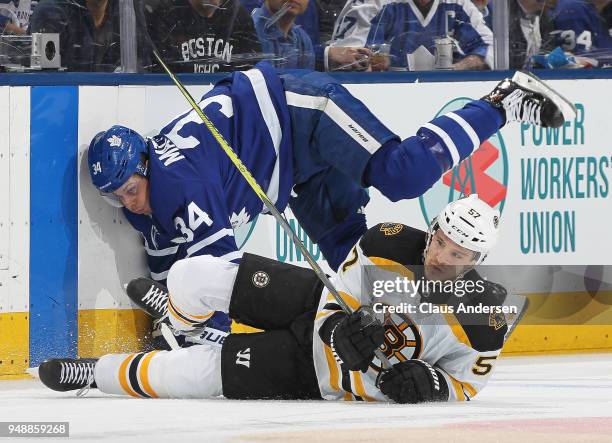 Tommy Wingels of the Boston Bruins collides with Auston Matthews of the Toronto Maple Leafs in Game Four of the Eastern Conference First Round in the...