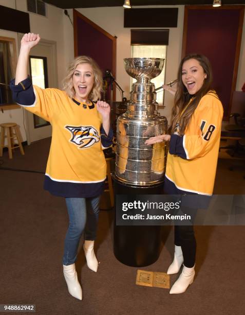 Madison Marlow and Taylor Dye of the group Maddie & Tae are seen with the Stanley Cup Trophy at Audio Productions on April 19, 2018 in Nashville,...