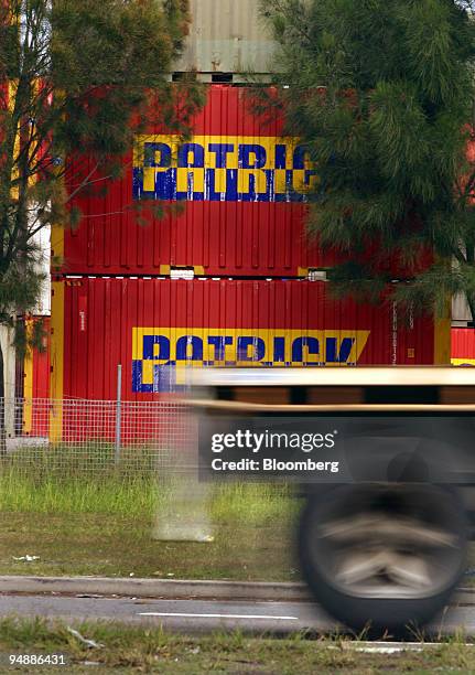 Transport truck passes by Patrick Corp. Containers at a port terminal in Sydney, Australia Thursday, May 19, 2005. Shares of Australia's biggest port...