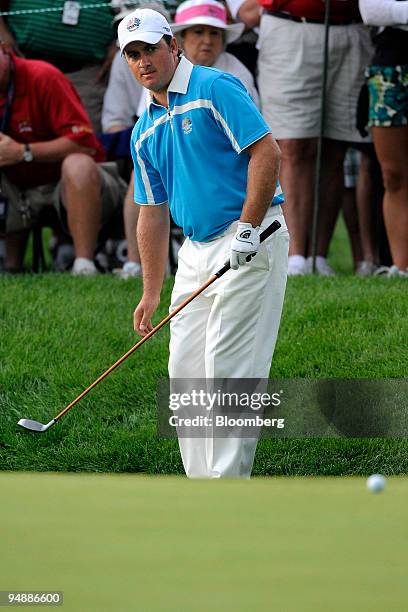 Golfer Graeme McDowell of the European team watches his chip shot go onto the green of the 5th hole during a morning foursome match on day two of the...