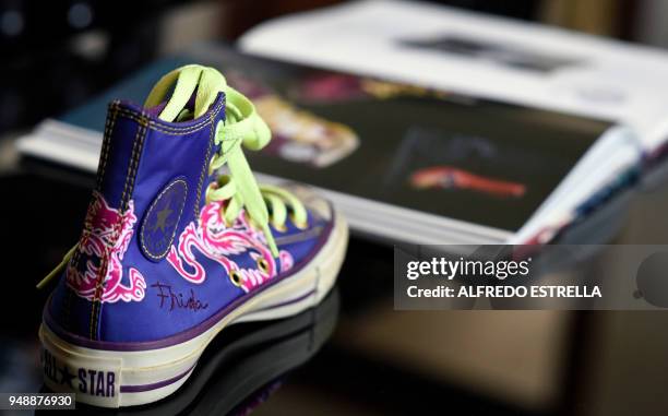 Tennis shoe with the signature of late Mexican artist Frida Kahlo, is exhibited -alongside other commercial products- at her sister's house in the...