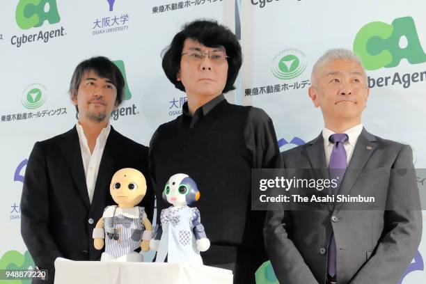 Osaka University Professor Hiroshi Ishiguro poses with Robot concierge 'CommU' and 'Sota' during a press conference on April 18, 2018 in Tokyo, Japan.