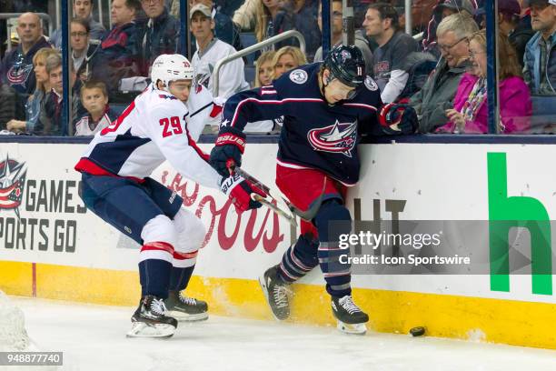 Columbus Blue Jackets left wing Matt Calvert and Washington Capitals defenseman Christian Djoos battle for the puck along the boards during game 4 in...