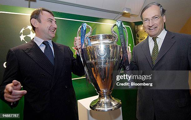 Anthony Ruys, right, the outgoing chief executive of Heineken with his replacement Jean-Francois van Boxmeer and the Champions League trophy, a...