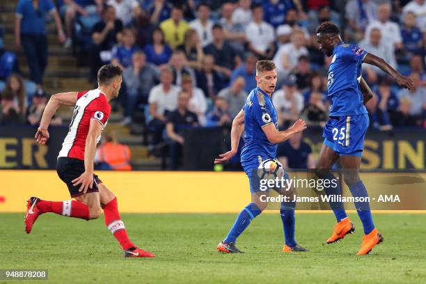 Dusan Tadic of Southampton and Marc Albrighton of Leicester City and Wilfred Ndidi of Leicester City during the Premier League match between...