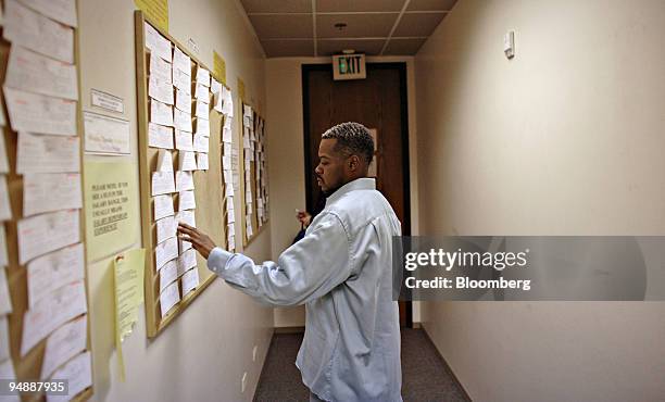 Michael Jarmon looks over job postings inside a Denver Workforce Center in Denver, Colorado, U.S., on Fri., Feb. 1, 2008. The U.S. Unexpectedly lost...